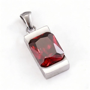Macro detail of a red rectangular faceted gemstone pendant set in a silver stainless steel base
