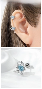 Detailed macro view of heart-shaped blue zircon stud earring with silver metal swirls