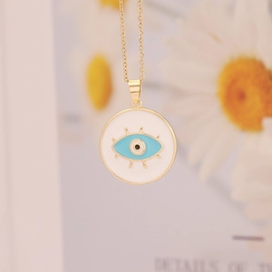 18K gold plated evil eye pendant necklace with white enamel disk on daisy background