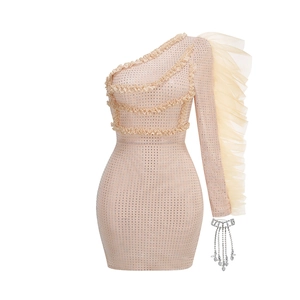 Detail of champagne ruffle dress with shimmering rhinestones and crystal tassel fringe