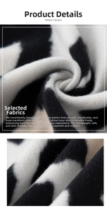 Macro detail of soft black and white cow print pashmina fabric showing fluffy texture