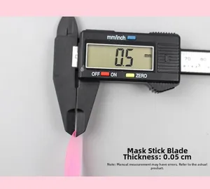 Macro shot showing 0.5mm thickness of pink plastic spatula using digital calipers