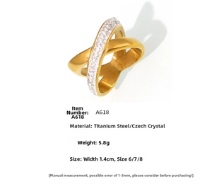 Detailed view of gold X-shaped crisscross ring with micro-pave rhinestones and 1.4cm width