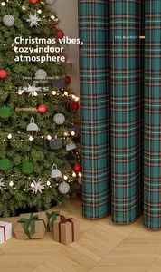 Detail of dark green plaid Christmas curtain with full blackout texture and pom poms