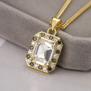 Macro shot of rectangular zircon pendant with black and white diamond halo on velvet