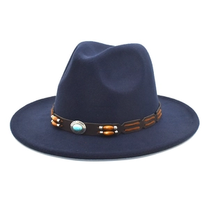 Detail of dark blue fedora hat featuring a brown leather band with wood beads and turquoise
