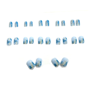 Blue marble press-on nails with gold foil accents, short round shape, 24 piece set