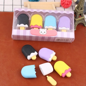 Detailed view of colorful dessert-shaped erasers in creative gift packaging on wood