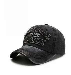 Detail of washed cotton baseball cap featuring 3D embroidery and leather-edged brim