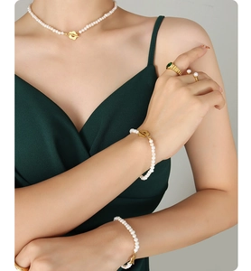 Detailed view of Baroque freshwater pearl necklace and bracelets with gold flower OT buckles