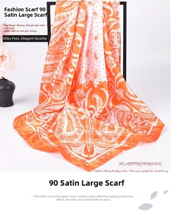 Detailed close-up of 90cm orange paisley satin square scarf with silky luster finish