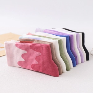 Gradient crew socks in pastel colors displayed at a 45-degree angle stack
