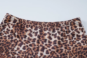 Detail view of the elastic waistband and fine stitching on leopard print knit pants
