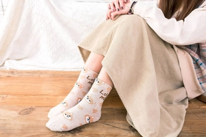 Detail of cotton crew socks featuring cute cartoon Shiba Inu patterns and Love Me text