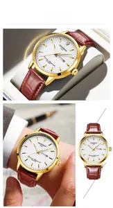 Detail of gold automatic watch with white dial, leather strap, and diamond marker