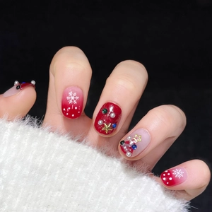 Handmade Christmas press-on nails with red glitter, snowflakes, and 3D pearl charms