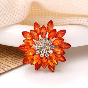 Macro shot of a gold alloy sunflower accessory with amber marquise rhinestones