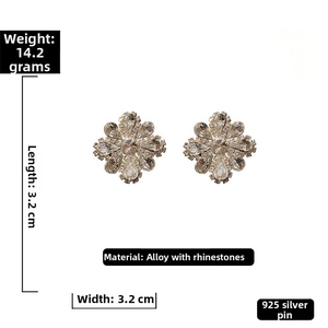 Detailed view of floral stud earrings featuring clear crystals and 925 silver needles