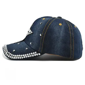 Detailed side view of a denim baseball cap with silver metal studs and yellow contrast stitching