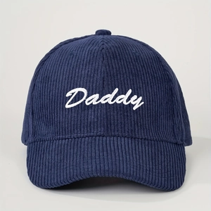 Detailed view of navy blue corduroy texture and white Daddy embroidery on baseball cap