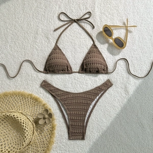 Coffee brown textured bikini set with drawstring ties laid on a white plush background