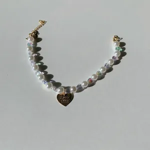 Elegant pet pearl necklace with colorful heart beads and a gold heart pendant