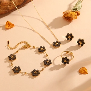Golden flower jewelry set with grey cat eye stones including necklace, bracelet and ring