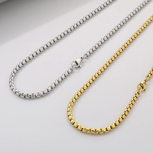 Detailed close-up of gold and silver stainless steel box chains with lobster clasps