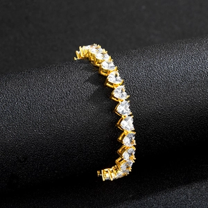 Detailed view of a gold-plated tennis chain featuring sparkling heart-shaped zirconia