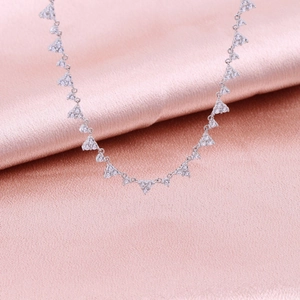 Detailed view of S925 sterling silver necklace with heart-shaped cubic zirconia on pink silk