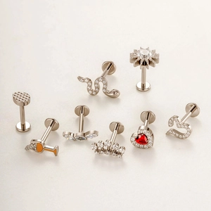 Collection of silver titanium stud earrings with heart, crown, and snake designs