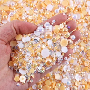 Close-up of mixed half-round pearls and AB color rhinestones for DIY nail art and crafts
