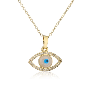 Macro detail of golden evil eye necklace with blue zircon pupil and clear crystal accents