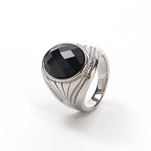 Detail of a vintage-style stainless steel ring with a faceted black gemstone and twisted rope band