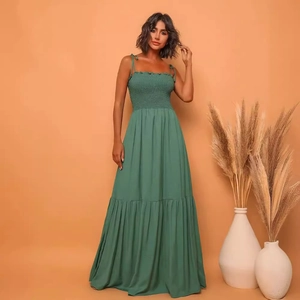 Elegant green pleated maxi dress with spaghetti straps and tiered skirt for women