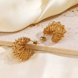 Elegant gold-plated spring coil hoop earrings on a stone base for a modern jewelry style