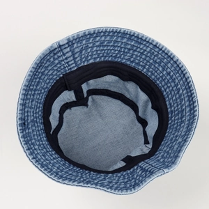 Blue denim bucket hat with internal view showing black sweatband and 100% cotton label