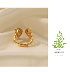 Detail of adjustable gold butterfly ring with dot embossing on silk fabric