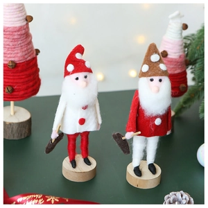 Detail of wool felt Santa gnomes with wooden base and Happy Christmas ribbon decoration