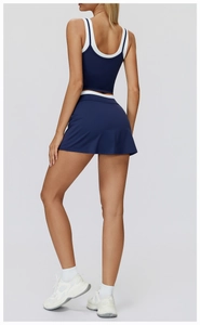 Back view of navy yoga set showing dual straps tank top and matching athletic skirt
