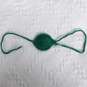 Detail of dark green handmade crochet nose prop for Halloween party photography