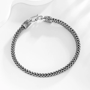 Macro shot of 4mm silver vintage snake chain with intricate braided texture and S-hook clasp