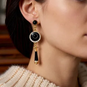 Vintage-style gold and black enamel drop earrings featuring sparkling zircon accents