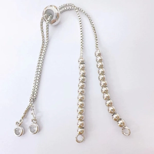 Macro detail of silver adjustable box chain with sliding bead clasp and zircon charms