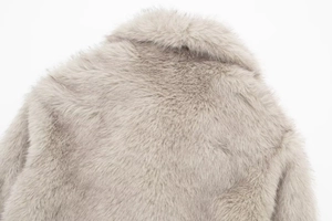 Macro shot of light gray faux fur coat detailing texture on neckline and shoulder