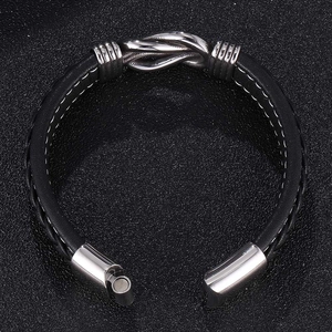 Detailed view of black woven leather bracelet with metal knot and magnetic clasp