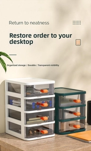 Close-up of clear desk storage boxes with orange handles and multi-layer drawer design