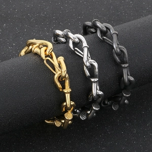 Macro view of interlocking nail link bracelets in gold, silver and matte black finishes