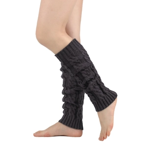 Detailed macro view of dark grey thick cable knit leg warmers with textured twist pattern