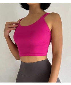 Detail view of pink sports bra stitching and high-elastic fabric for gym yoga